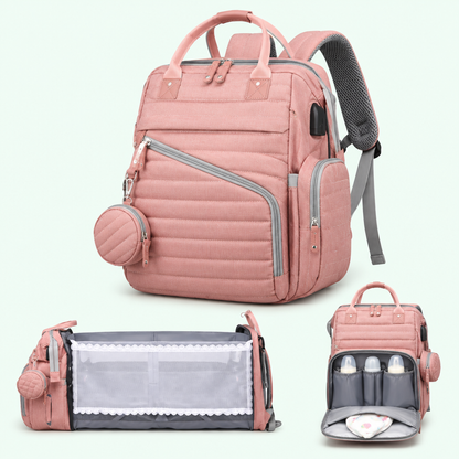 NappyGo Wickelrucksack in Rosa mit Schnullerbox und aufgeklapptem Babybett